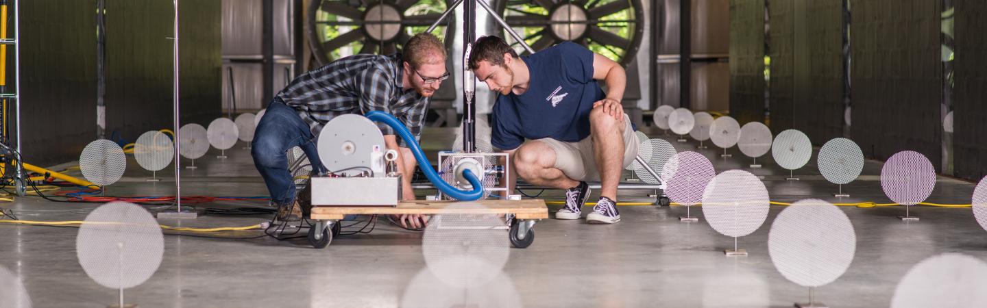 UNH researchers examine sensor readings while performing experiment in the university's cutting-edge wind tunnel. 
