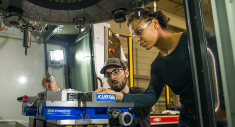 UNH researchers working with machinery