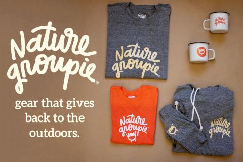 Nature Groupie logo with sweatshirt, tshirt, and tin mug merchandise on table