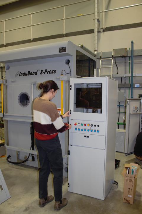 Maria Virga, process engineer at GreenSource Fabrication, working with the new InduBond X-Press at UNH's Olson Center